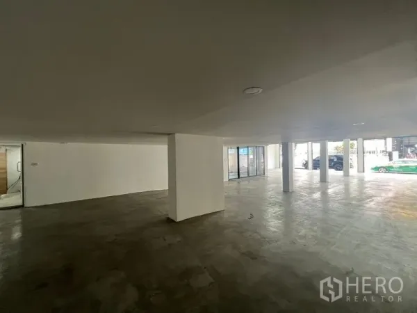 Office Space for rent or sale in Wang Thonglang, Bangkok - Covered ground-floor parking and entrance area with concrete floor and columns.