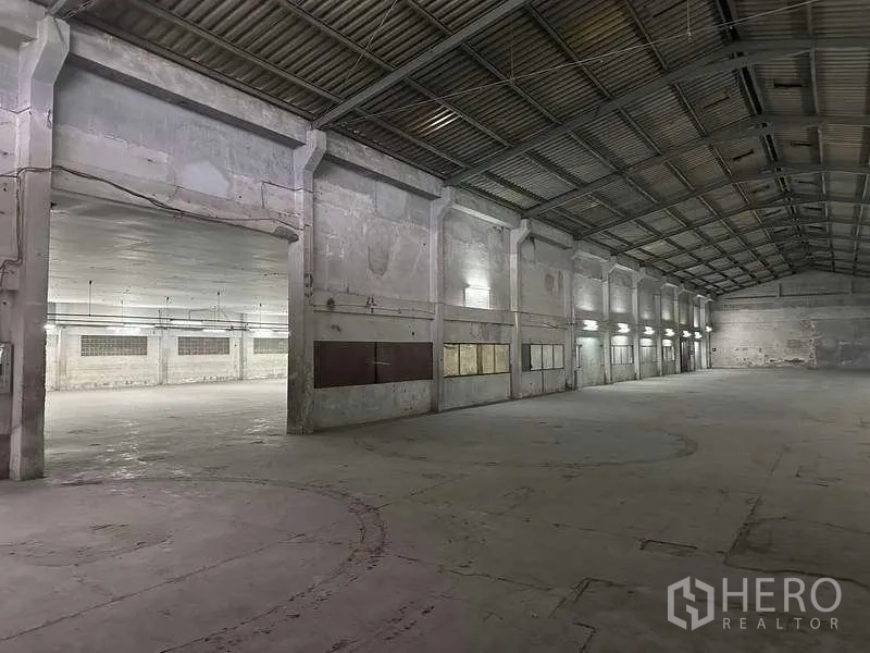 Factory for rent or sale in Bang Phli, Samut Prakan - Large factory floor with high roof, concrete columns and open production space.