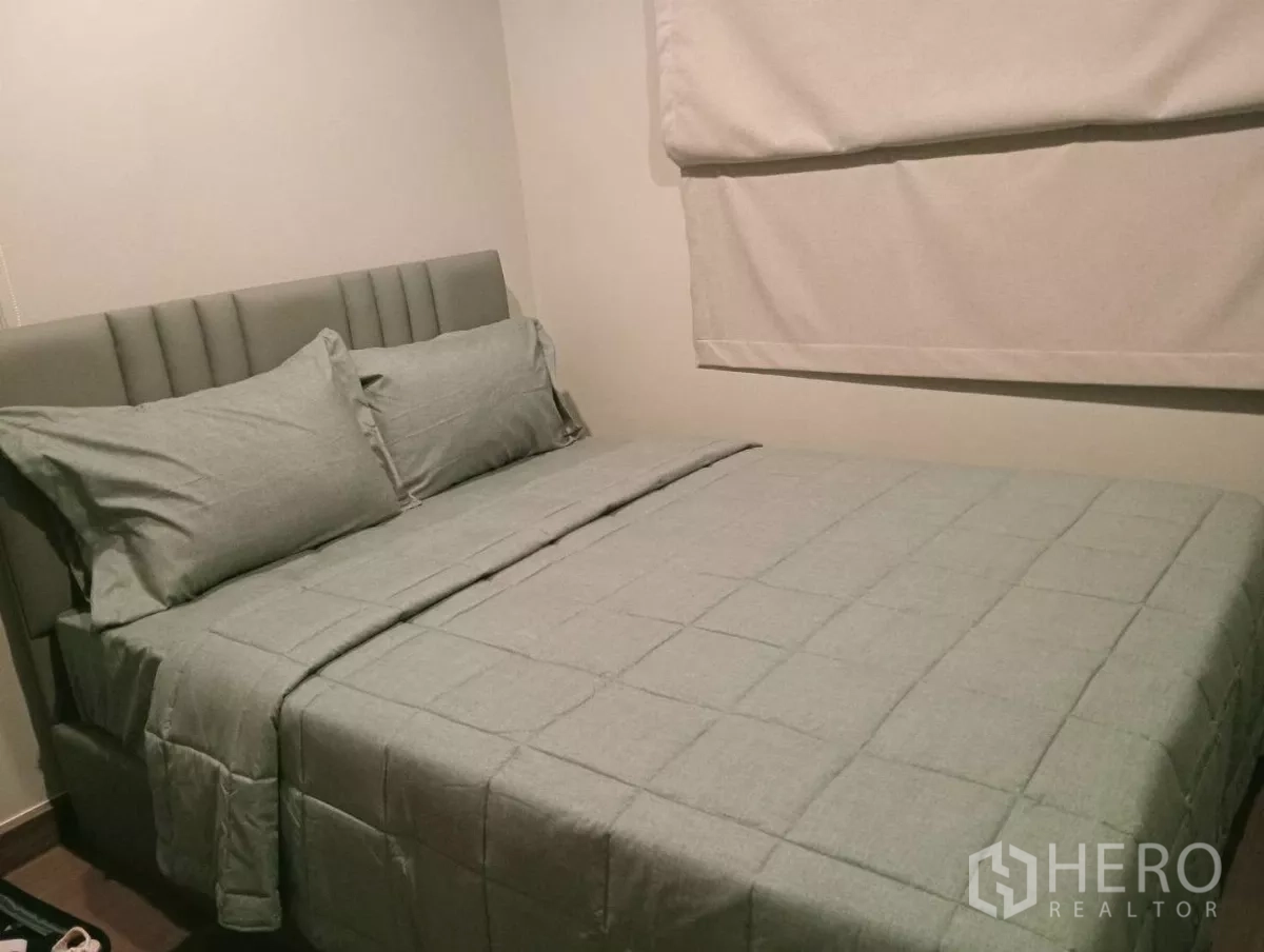 Detached House for rent in Samut Prakan - Third bedroom with padded headboard bed, neutral decor and blackout blind.