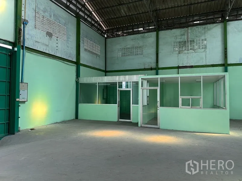 Factory for rent in Bang Bo, Samut Prakan - Glass-partitioned internal office under high roof inside the factory.