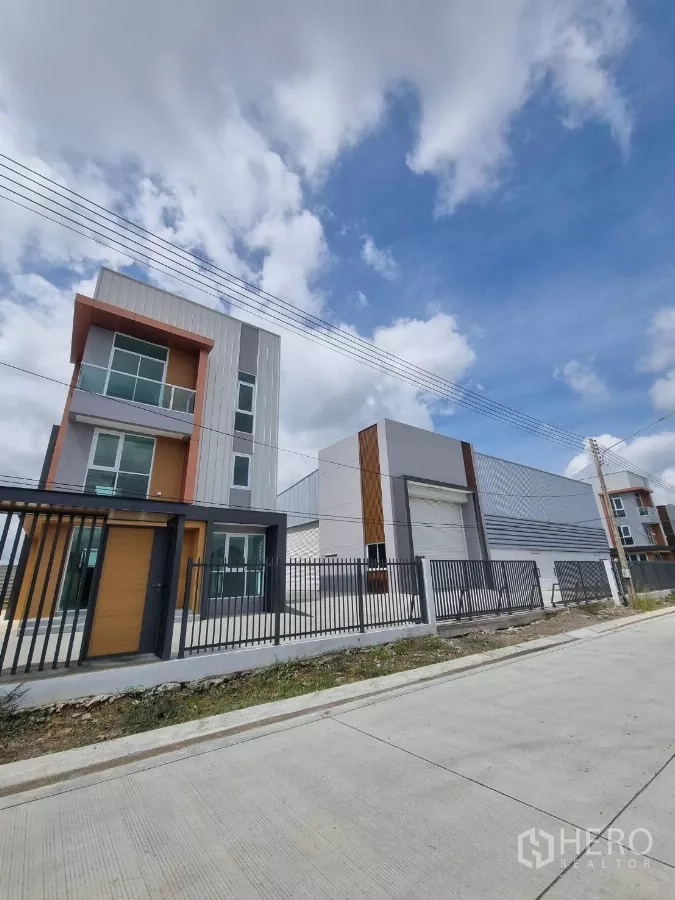 货栈 出售在Lam Luk Ka, Pathum Thani - 街景：围栏后可见办公楼与连接仓库。