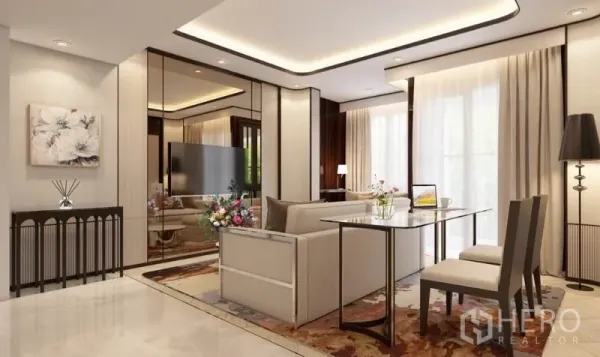 Condominium for rent in Watthana, Bangkok - Open‑plan lounge with cream sofa, wall mirror panels, TV, and a two‑seat dining table beside sheer curtains.