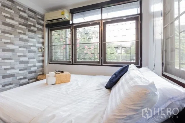 Detached House for rent in Watthana, Bangkok - Second bathroom with gray tiles, toilet and glassless walk‑in shower.
