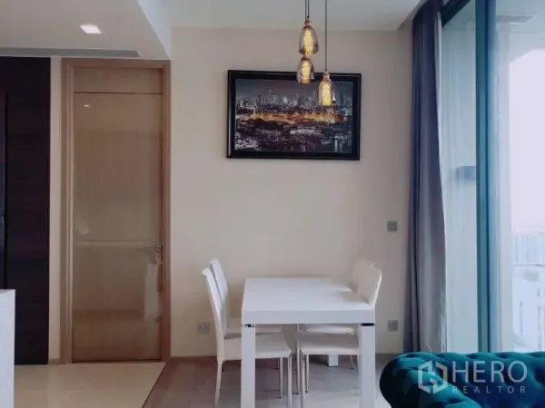 Condominium for rent or sale in Watthana, Bangkok - Bright dining nook with pendant lights beside sliding glass doors to the balcony.