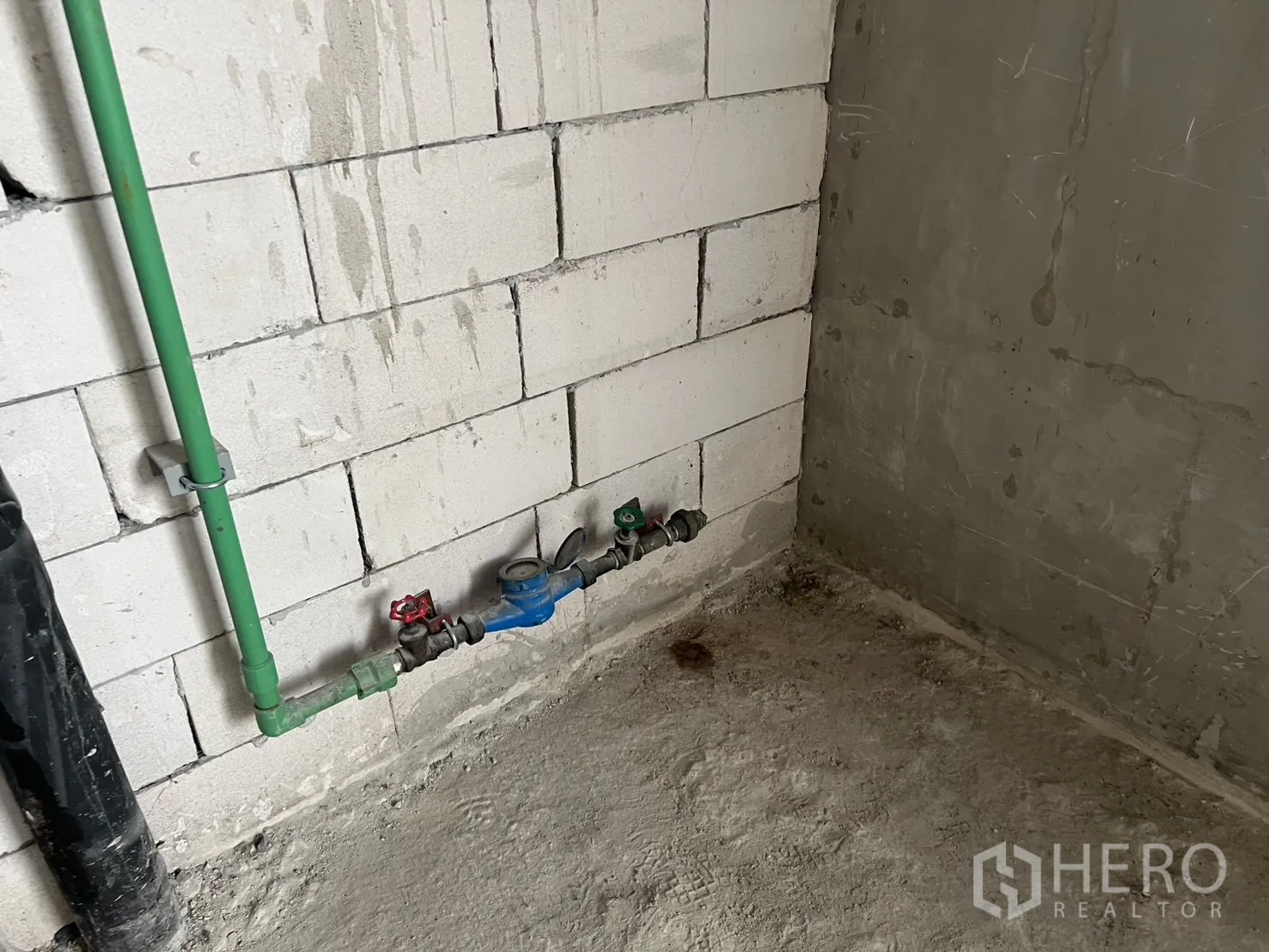 Retail Space for rent in Pathum Wan, Bangkok - Water supply and meter piping installed against a block wall.