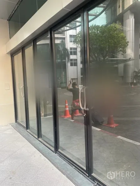 Retail Space for rent in Khlong Toei, Bangkok - Street-facing glass storefront with black aluminum frames and sliding doors.