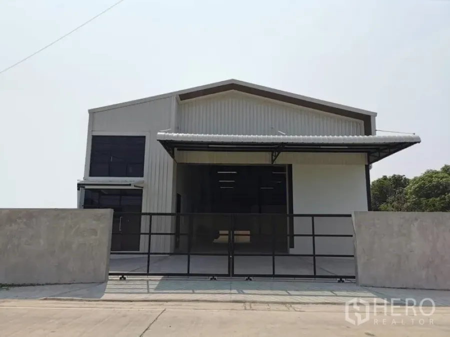 คลังสินค้า ให้เช่าในBang Kruai, Nonthaburi - หน้ากว้างของโกดังติดถนน มีกำแพงและประตูเลื่อน พร้อมชายคาลานโหลด