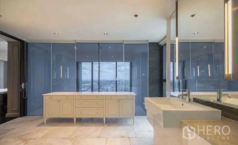 Condominium for rent - Large vanity bathroom with glass partitions and skyline backdrop.
