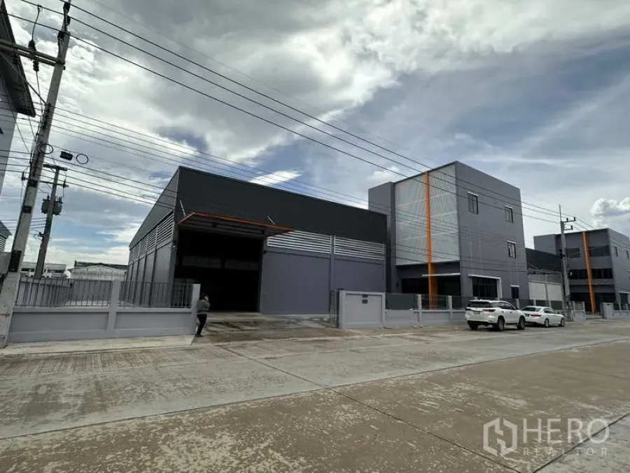 Factory for rent or sale in Lam Luk Ka, Pathum Thani - New industrial factory with three-storey office block and gated entrance on a wide concrete road in Lam Luk Ka.