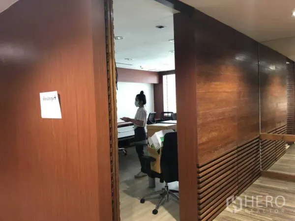 Office Space for sale in Watthana, Bangkok - Entrance to workspace with wooden partitions and desks inside.