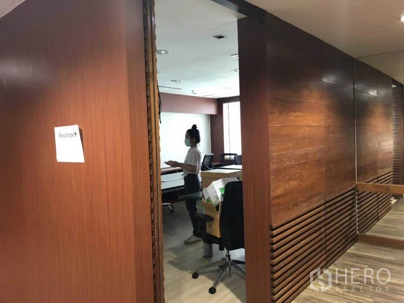 Office Space for sale in Watthana, Bangkok - Entrance to workspace with wooden partitions and desks inside.