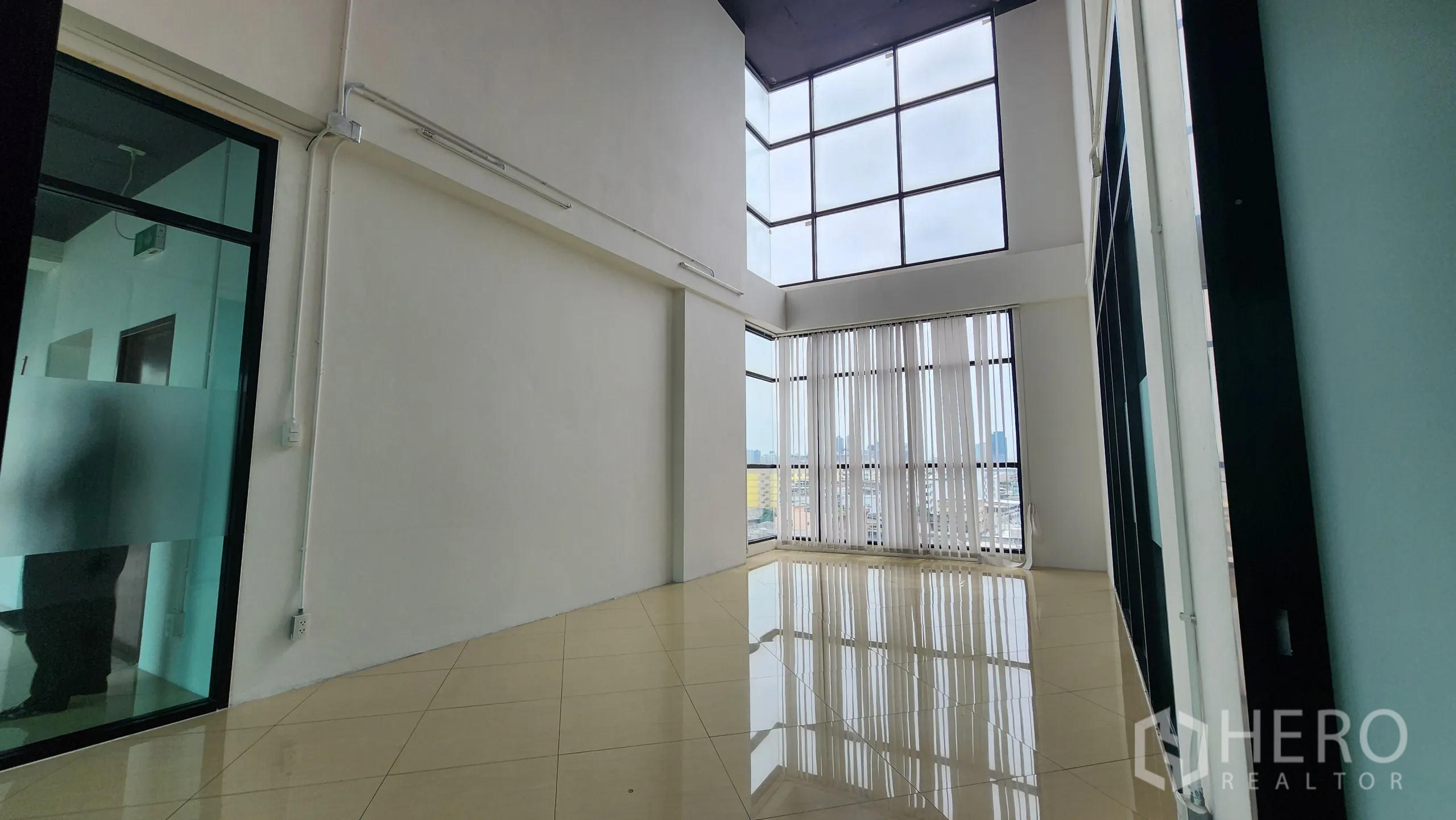 办公空间 出租在Yan Nawa, Bangkok - 挑高工作区，竖百叶与磨砂玻璃隔断。