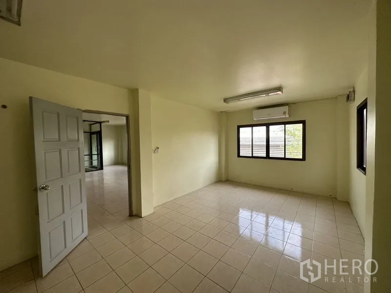 Factory for rent in Bang Bua Thong, Nonthaburi - Private office with window and wall-mounted air conditioner.