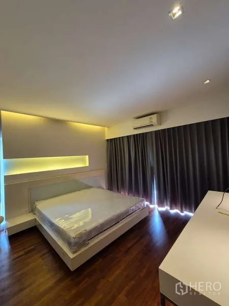 Detached House for rent in Bang Kruai, Nonthaburi - Master bedroom with accent lighting, blackout curtains, air conditioning and warm wood flooring.