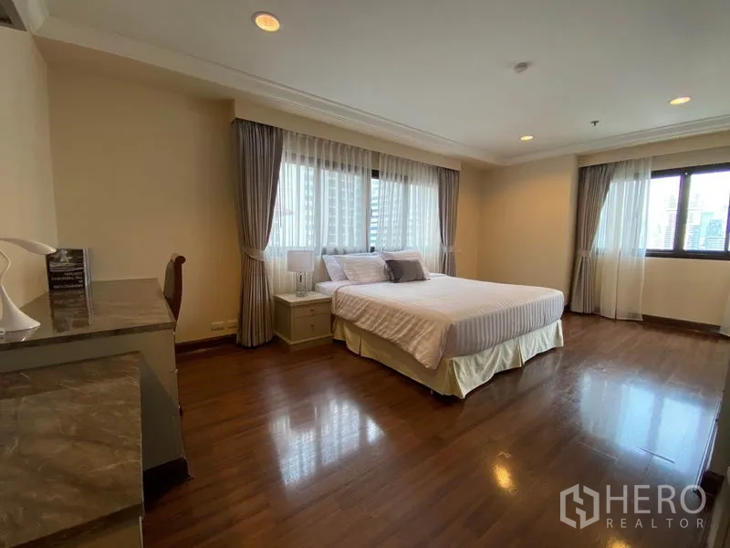 公寓 出租在Watthana, Bangkok - 第三卧室配双人床、转角窗与书桌，可见城市景观。