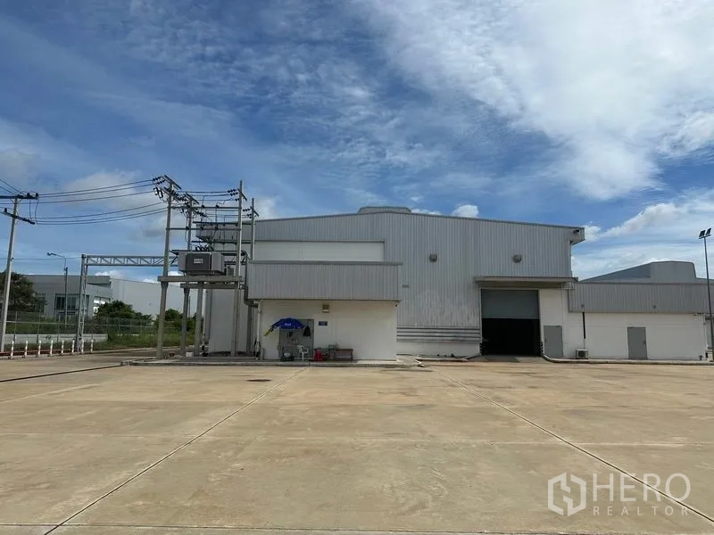 Factory for rent in Bang Sao Thong, Samut Prakan - Factory facade with dedicated transformer yard and a large roller door on spacious hardstand.