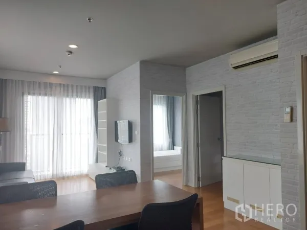 公寓 出租在Watthana, Bangkok - 开放式餐客一体空间，纱帘与木地板通向卧室