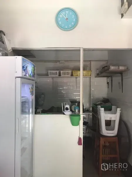 零售空间 出租在Watthana, Bangkok - 室内备餐区，含操作台、冰箱、置物架与白色瓷砖墙。