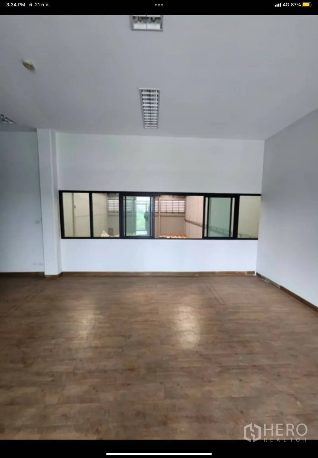 Factory for rent in Samut Prakan - Large office space with long internal viewing window into the warehouse area.