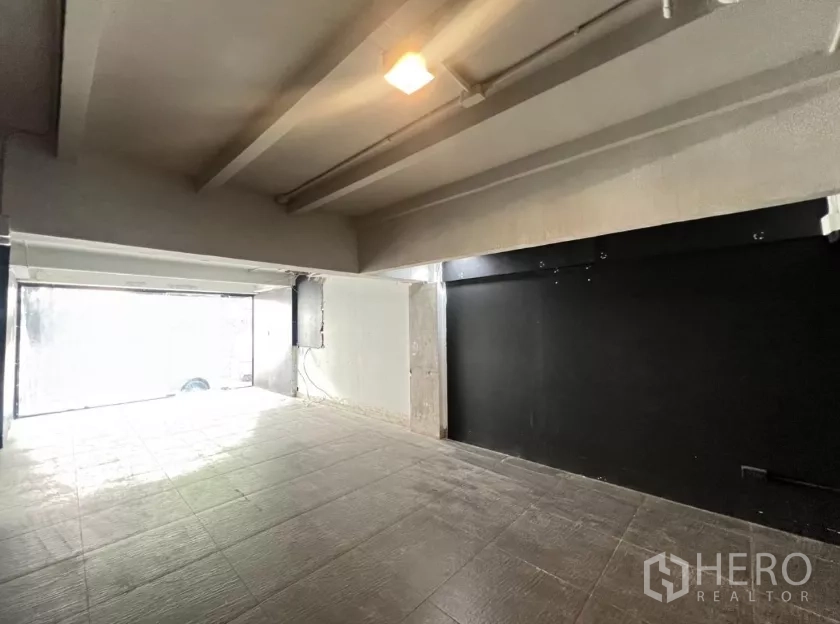 Retail Space for rent in Watthana, Bangkok - Bright front retail zone with large glass window and black accent wall.
