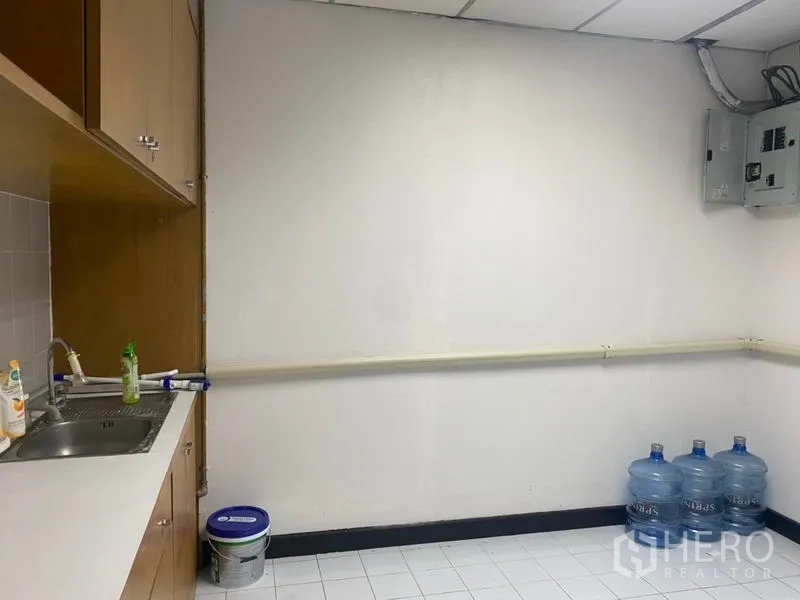 Office Space for rent in Din Daeng, Bangkok - Service room with sink counter, wall cabinets and utility area with power panel.