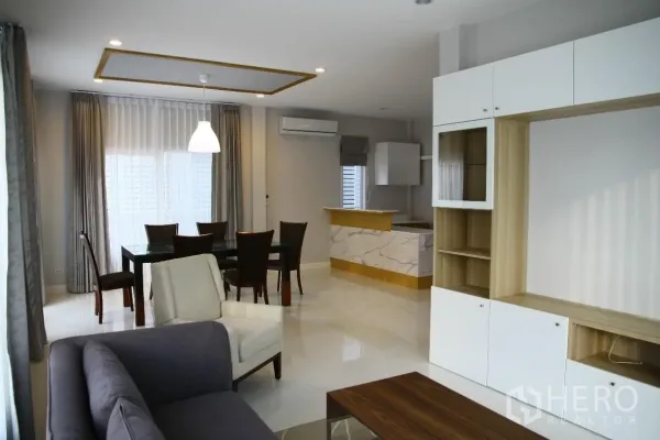 บ้าน ให้เช่าหรือขายในBang Na, Bangkok - โถงรับแขกและรับประทานอาหารแบบเปิดโล่ง พร้อมโซฟา โต๊ะทานอาหาร ตู้บิลท์อิน และเคาน์เตอร์หินอ่อน ใกล้หน้าต่างบานใหญ่