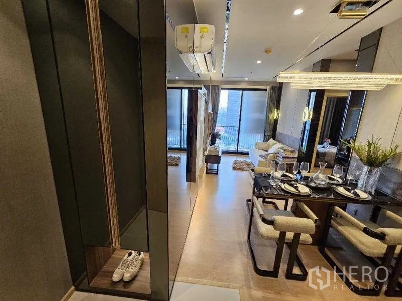 Condominium for rent - Entry corridor leading to open-plan living and full-height windows.