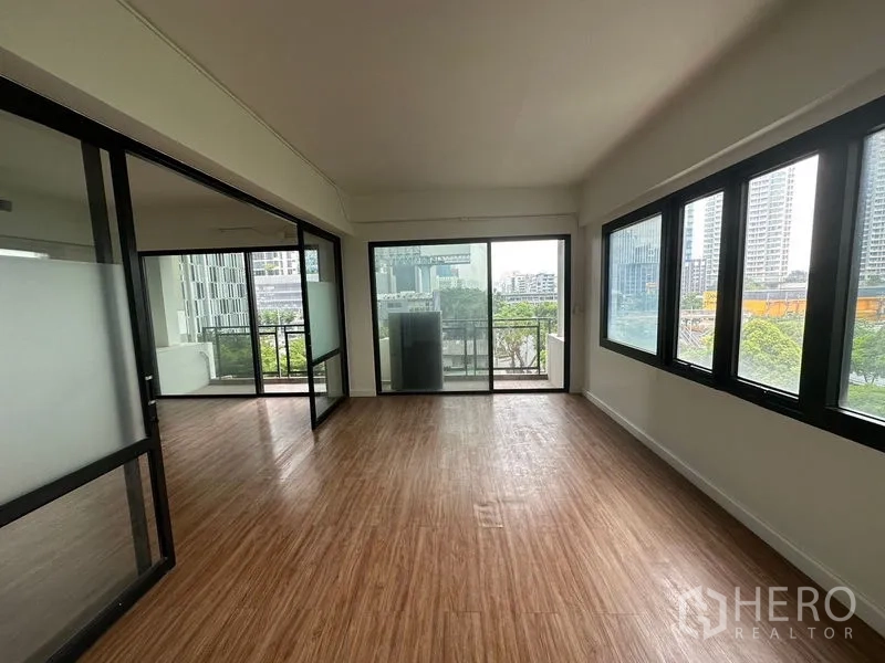 Office Space for rent in Sathon, Bangkok - Corner workspace with large windows and sliding doors to a balcony overlooking the skyline near Chong Nonsi.