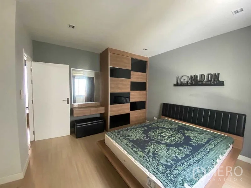 Home Office for rent or sale in Bang Phli, Samut Prakan - Bedroom with wooden wardrobe, dressing table and upholstered headboard.