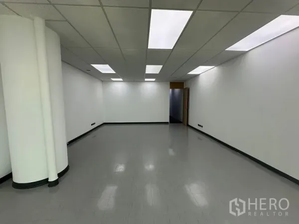 Office Space for rent - Large empty office room with smooth vinyl flooring, white columns, and recessed lighting.