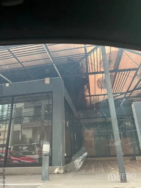 Retail Space for rent in Khlong Toei, Bangkok - Street-level retail unit with a glass storefront, metal canopy and covered walkway in Khlong Toei, Bangkok.