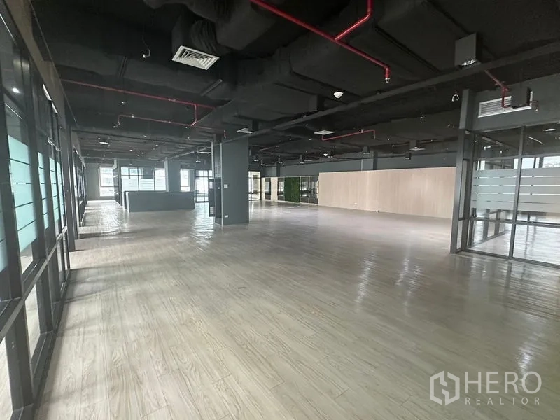 Office Space for rent in Bang Rak, Bangkok - Wide office zone with exposed services and frosted glass rooms.