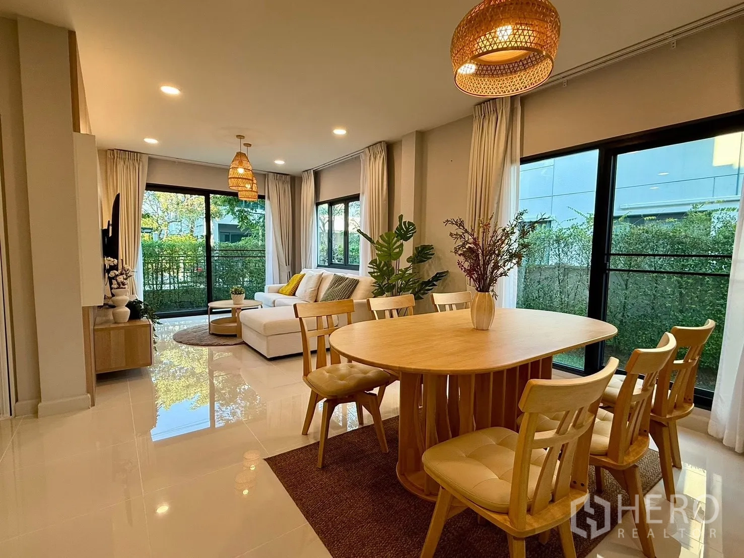 Detached House for rent in Bang Phli, Samut Prakan - Open-plan dining and living area with large windows and garden view.