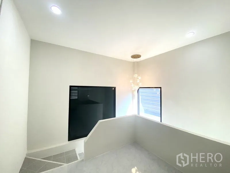 Warehouse for rent in Mueang Pathum Thani, Pathum Thani - Stair landing with natural light, modern pendant light and side windows.