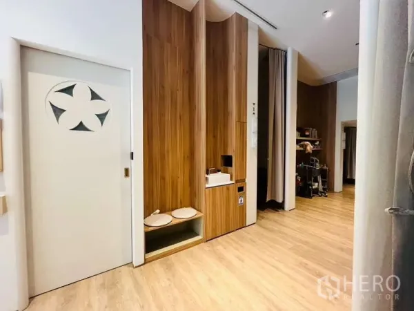 Retail Space for rent - Interior corridor with wood paneling, built-in sink, and high ceilings suitable for back-of-house use.