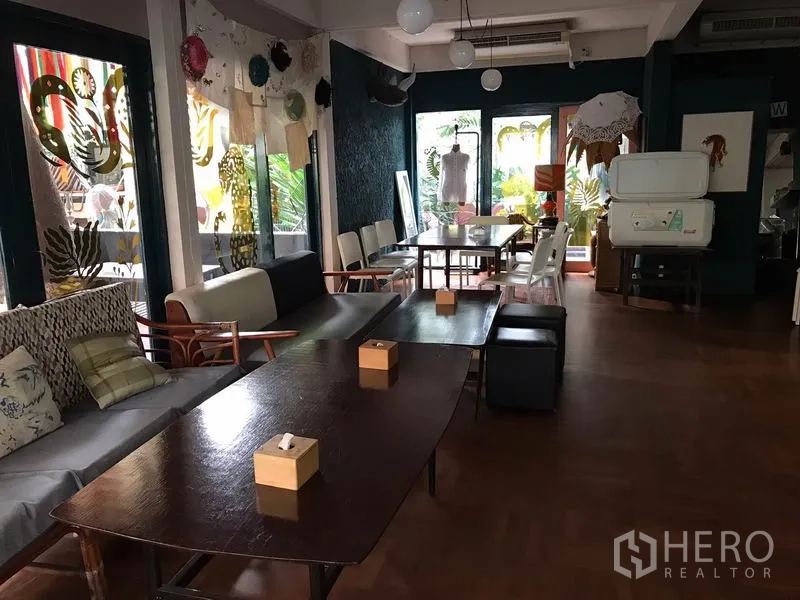 Retail Space for rent in Watthana, Bangkok - Cozy indoor dining area with wooden tables, sofa seating and pendant lights.
