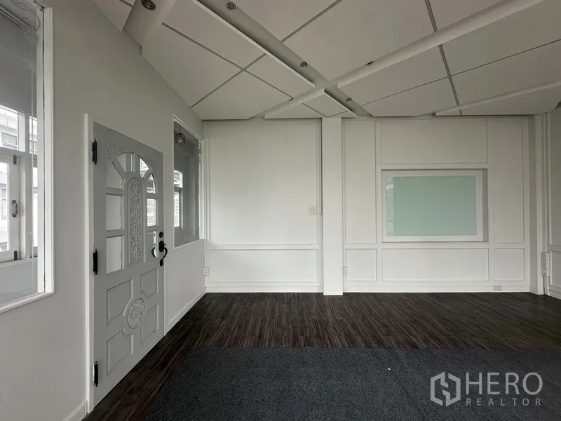 Retail Space for rent in Bang Rak, Bangkok - Interior entrance area with decorative door, paneled walls, and acoustic ceiling.