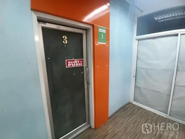Office Space for rent in Ratchathewi, Bangkok - Numbered office door with push handle set in an orange-framed entry along the corridor.