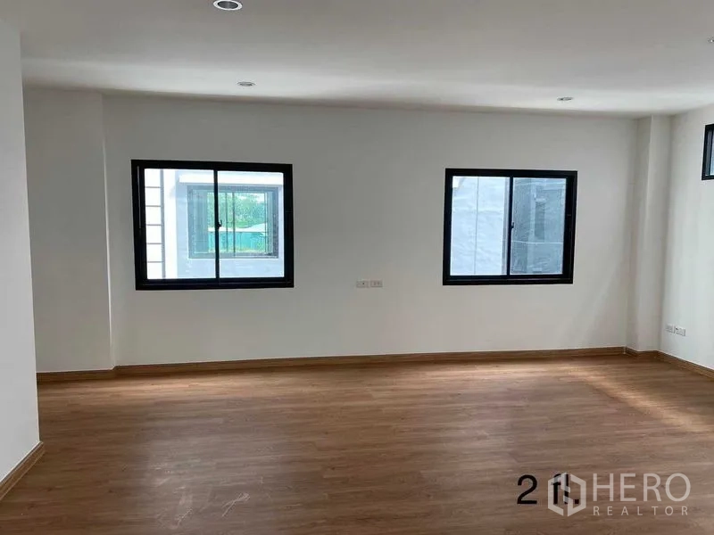Home Office for rent or sale in Bang Phli, Samut Prakan - Bright secondary room with multiple sliding windows and laminate flooring.