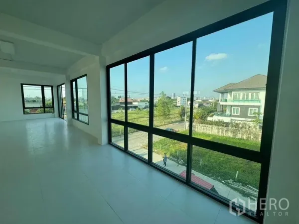 Home Office for rent in Don Mueang, Bangkok - Upper-floor workspace with floor-to-ceiling corner windows overlooking the neighborhood.