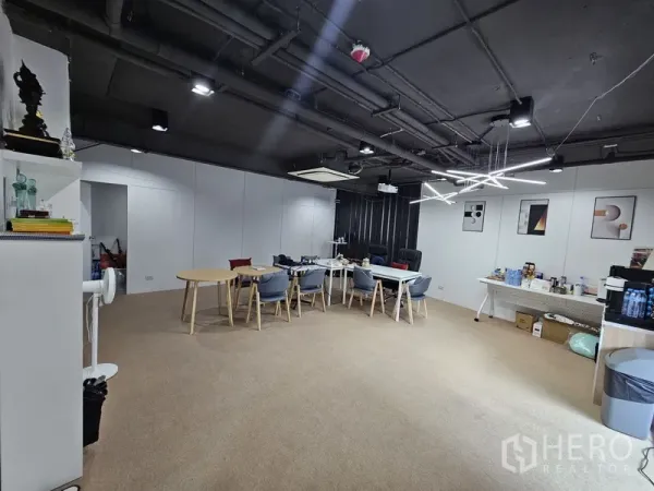 Retail Space for rent - Spacious office-style room with contemporary lighting, white partitions, and meeting tables.