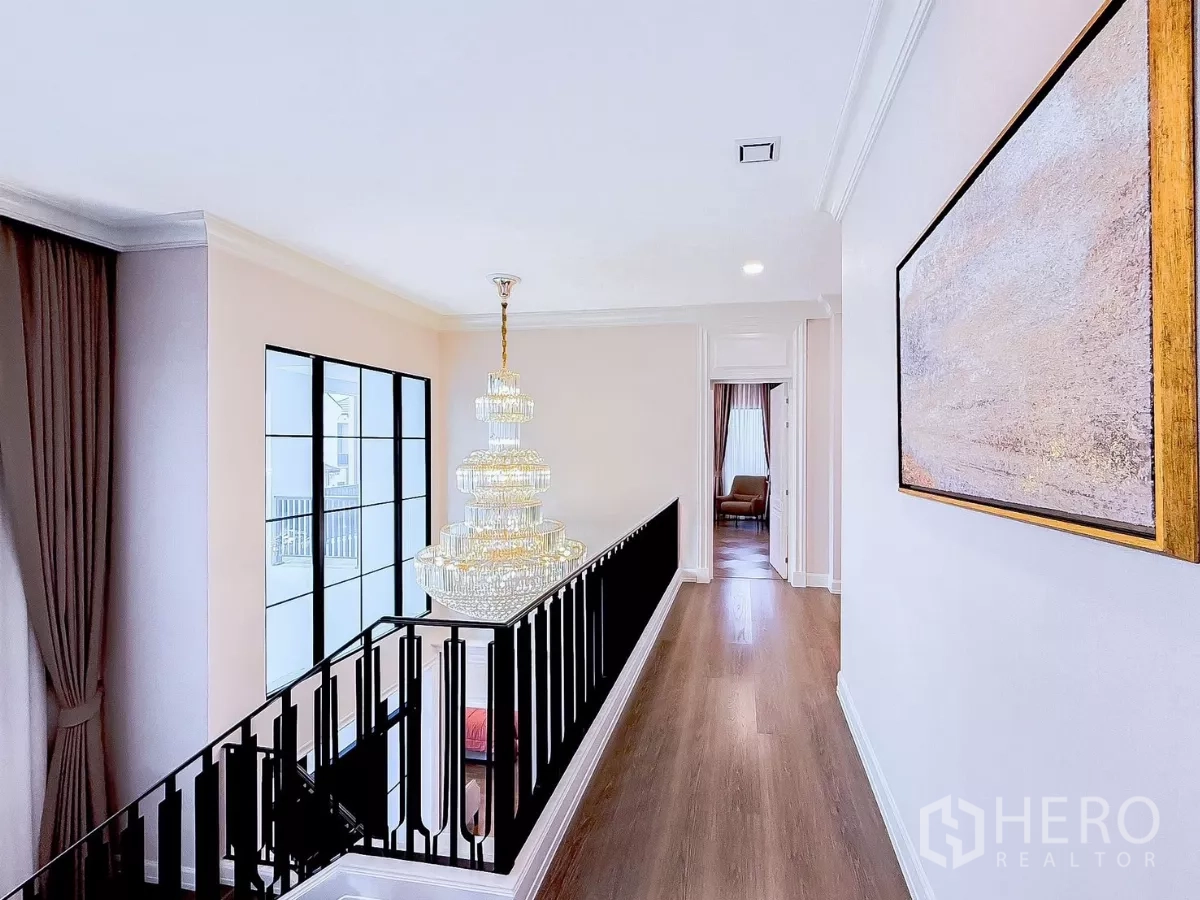 Detached House for rent in Saphan Sung, Bangkok - Upper landing with modern chandelier and floor-to-ceiling window.