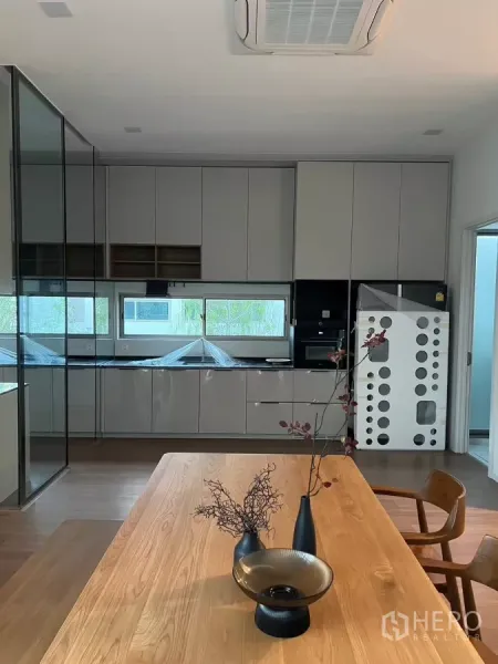 Detached House for rent in Saphan Sung, Bangkok - Modern kitchen with full-height cabinetry, window strip and built-in appliances.