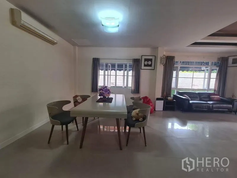 Detached House for rent in Sai Mai, Bangkok - Dining area with four chairs, central light and windows on two sides.