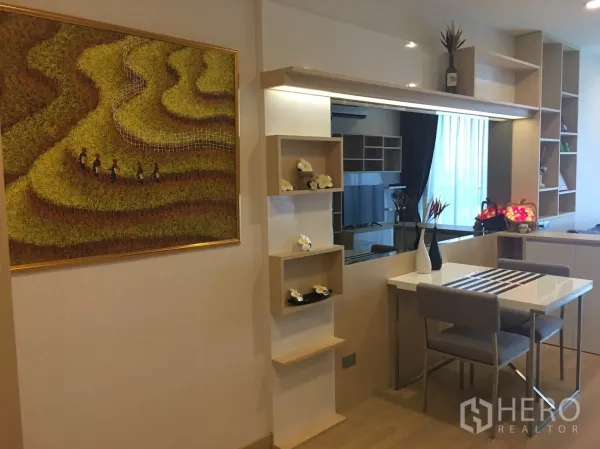 Condominium for rent in Watthana, Bangkok - Compact dining nook with built-in shelves, mirror backsplash, and modern table and chairs.