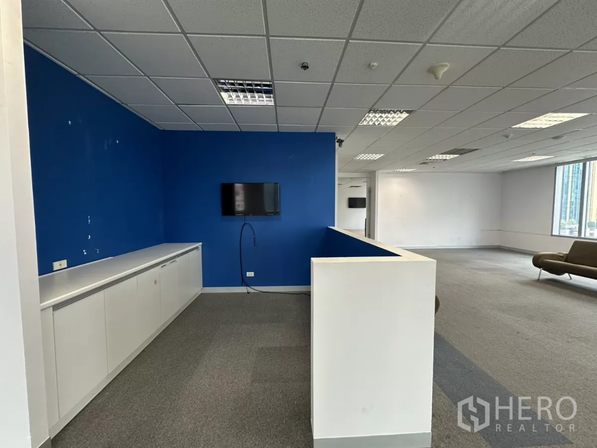 Office Space for rent in Watthana, Bangkok - Reception counter with blue accent wall, storage cabinets and lounge seating.