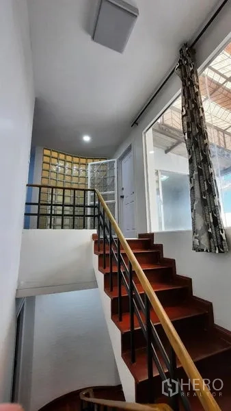 Townhouse for rent or sale in Suan Luang, Bangkok - Staircase to terrace with glass-block wall and natural light.