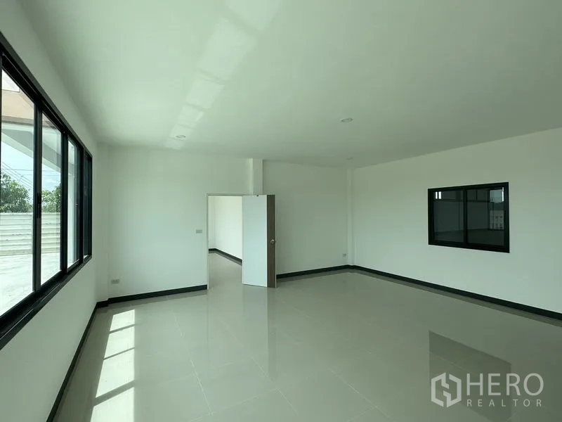 Factory for rent or sale in Sai Noi, Nonthaburi - Bright two‑storey office room with large black‑framed windows and glossy tiled flooring.