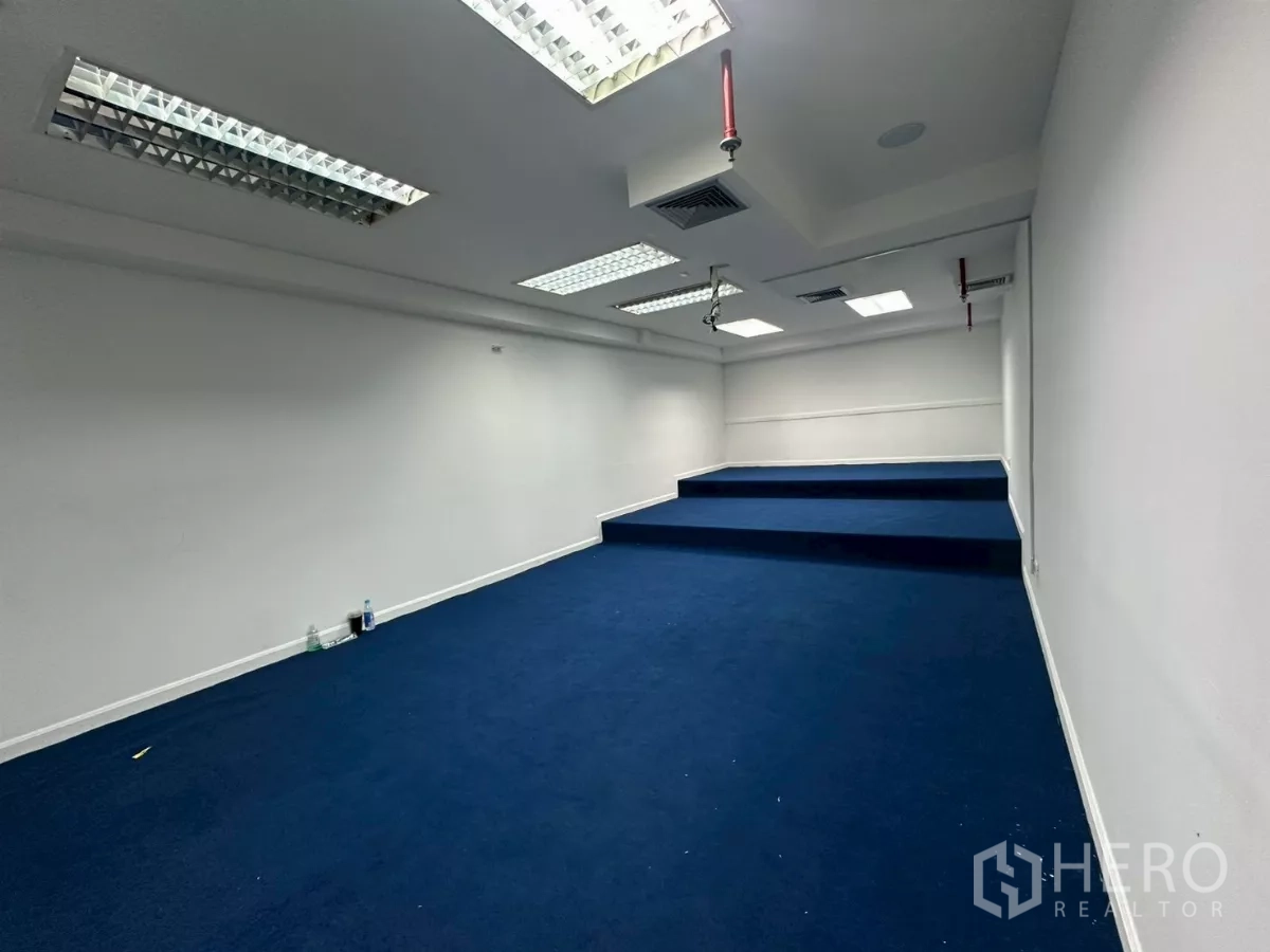 Office Space for rent in Khlong Toei, Bangkok - Tiered presentation or training room with blue carpet and recessed lighting.