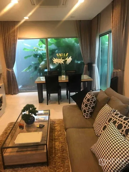 Detached House for rent or sale in Bang Kapi, Bangkok - Open-plan living and dining area with large windows to lush greenery.